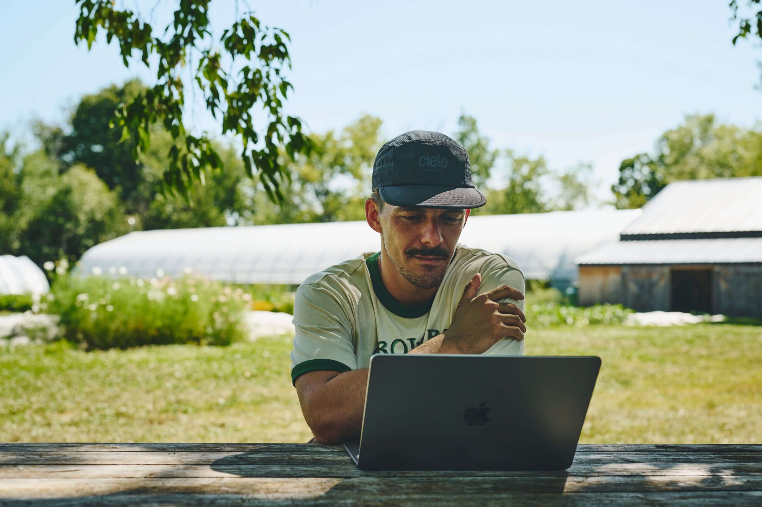 Man sitting in front of his computer outside